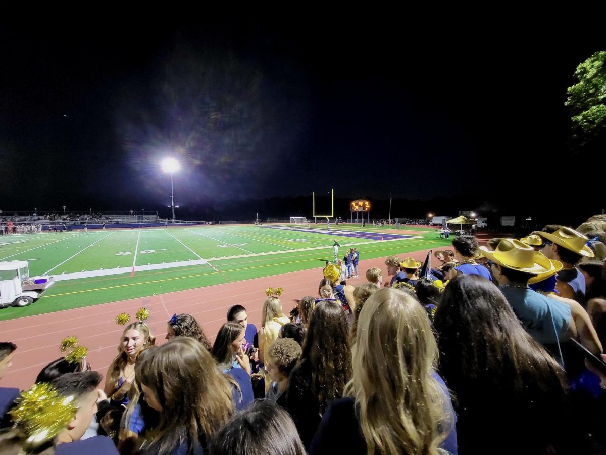 Students showing school spirit at a fall football game